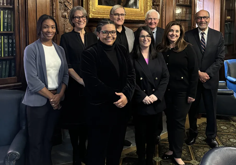 Group of professionally dressed individuals in an office setting