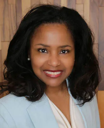 Professional headshot of woman with dark hair smiling